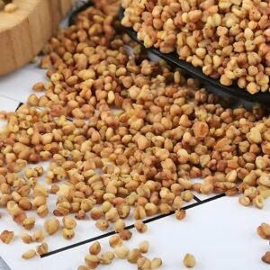 A close-up view of premium, dry roasted Nutty Tartary Buckwheat kernels exhibiting a rich, even golden-brown color, highlighting their pure roasted-grain character.